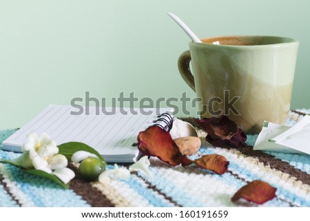 Tea glass and note pad on bar for take a break and relax time