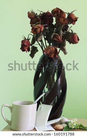 Tea glass and rose vase on table for take a break and relax time