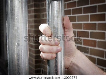 hand on prison bars