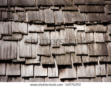 A wooden roof made of ricketty differently sized wooden tiles
