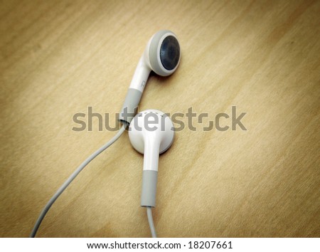 White Headphones on a wooden background
