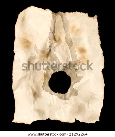 Hole burnt into worn out and tea stained paper, isolated on a black background