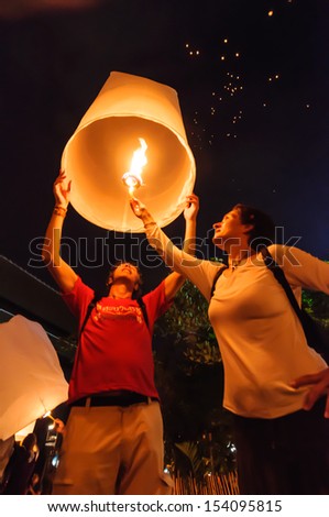 CHIANG MAI THAILAND-NOVEMBER 28 : Tourist launching sky lantern in Loy Krathong and Yi Peng Festival on november 28, 2012 Chiangmai, Thailand
