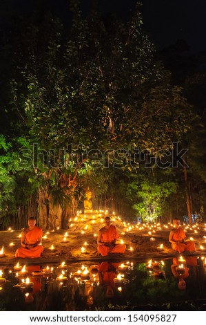CHIANG MAI THAILAND - NOVEMBER 28 :Group of monks sitting meditation in the sacred ritual at Wat Phan Tao temple in Loy Krathong and Yi Peng Festival on November 28, 2012 in Chiangmai,Thailand.