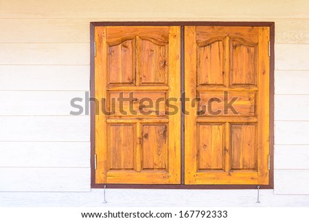 Wooden windows on the wooden wall