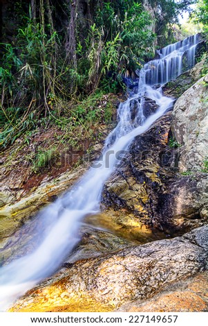 Beautiful silky waterfall flow through stones, Huay Kaew Waterfall, Chiang mai Province, Thailand.