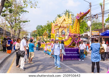 CHIANG MAI,THAILAND-FEBRUARY 08 : People are interested in coming to visit fresh flowers decorate car in annual 39th Chiang Mai Flower Festival,  on February 08, 2015 in Chiang Mai,Thailand.