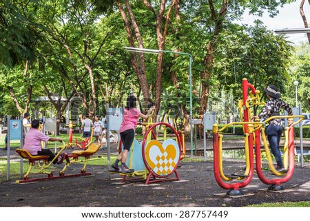 BANGKOK, THAILAND - JUN 13 : People exercising with exercise equipment this morning in the Jatujak public park on jun 13, 2015 in Bangkok, Thailand.