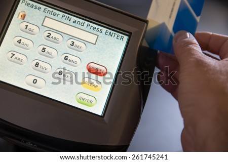 This shot is to capture the movement of a person swiping a card through a electronic funds payment terminal- debit and credit card processing.