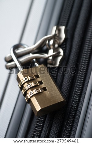 Close up shot of luggage with a combination lock attached.