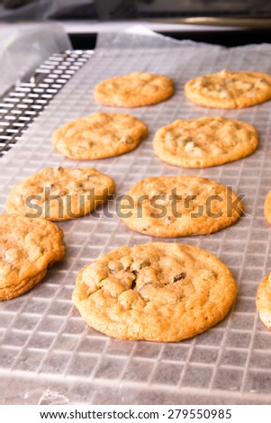 Freshly baked cookies resting on a baking rack.