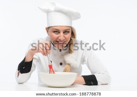 Real cook chef smiling and holding mixer in cup