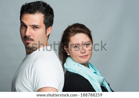 Modern family couple back to back posing and supporting each other