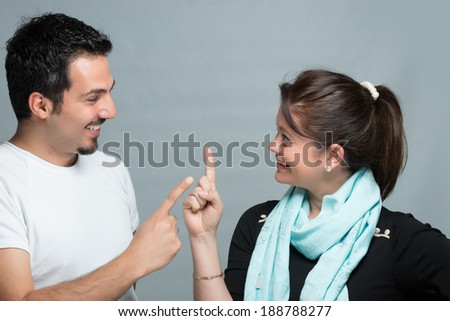 Wife and husband talking each other with finger gestures