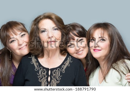 An older mother with three daughter all smiling and having fun