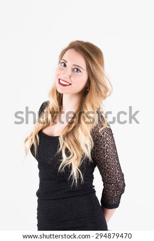 Elegant blonde woman in black dress smiling with confidence. Half body shot