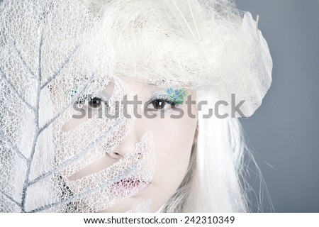 Winter Woman Portrait. Snow. Beauty Fashion Model Girl with White Hair  closeup. Make up. Asia