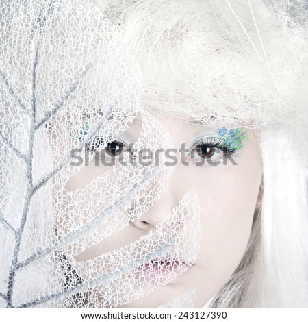 Winter Woman Portrait. Snow. Beauty Fashion Model Girl with White Hair closeup. Make up. Asia model face. Close up