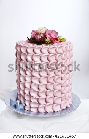 Beautiful wedding cake, with pink roses. Omb-re cake with fresh flowers.  Cake for holidays. Gorgeous cake covered in roses made of butter cream icing sitting on a cake pedestal