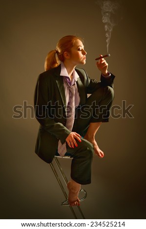 Girl in business suit smoking a cigar