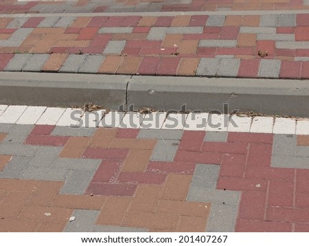 driveway and sidewalk laid out with decorative brick