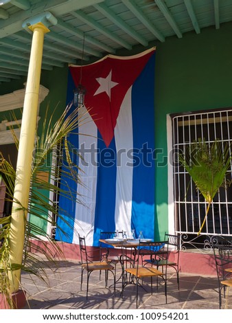 Old house with a cuban flag in the colonial town of Trinidad in Cuba, a famous touristic landmark on the caribbean island