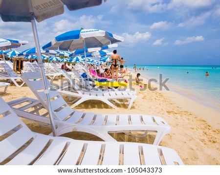 VARADERO,CUBA-JUNE 03:Tourists sunbathing at the beach June 03,2012 in Varadero.With over a million visitors per year,Varadero is the most important destination for the growing cuban tourism industry
