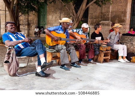 HAVANA-JULY 20:Unidentified men in a traditional music group playing for tourists July 20,2012 in Havana.The cuban music is an attraction for more than 2 million people who visit Cuba every year