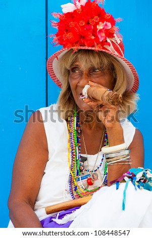 HAVANA-JULY 20:Unidentified old lady smokes a fine Cuban cigar July 20,2012 in Havana.The African culture have a huge influence in Cuba where approximately 50% of the population is of African descent