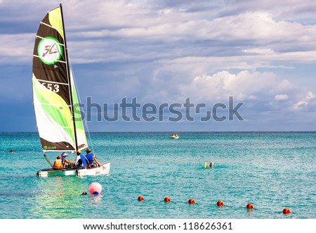 VARADERO,CUBA-NOVEMBER 3:Family of tourists sailing November 3,2012 in Varadero.With over a million visitors per year,Varadero is the main destination for the growing cuban tourism industry