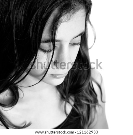 Black and white portrait of a beautiful sad hispanic girl isolated on a white background with space for text