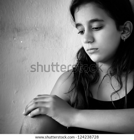 Black and white portrait of a sad and lonely girl