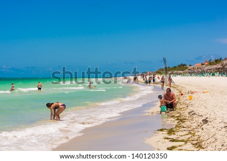VARADERO,CUBA-MAY 19:Happy family enjoying the beach May 19,2013 in Varadero.With the growing flow of foreign visitors,tourism in Cuba grew 4.5% in 2012 with Varadero being its main destination