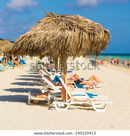VARADERO,CUBA-MAY 19:Vacationers sunbathing at the beach May 19,2013 in Varadero.With the growing flow of foreign visitors,tourism in Cuba grew 4.5% in 2012 with Varadero being its main destination