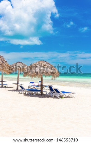 Umbrellas on a tropical beach at Coco Key (Cayo Coco) in Cuba (on a beautiful sunny summer day)