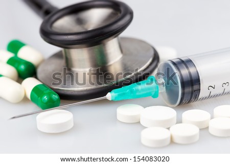 Stethoscope,pills and syringe on a white background useful to illustrate any medical subject