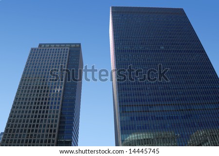 Two skyscrapers with a clear sky background