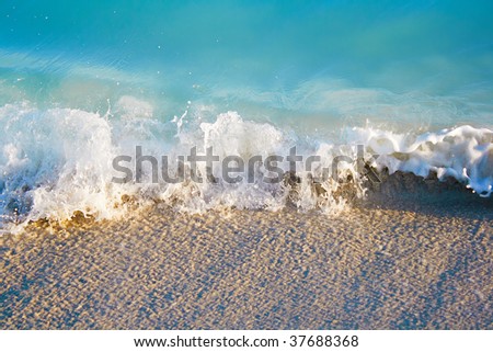 Small sea waves ending in the sand