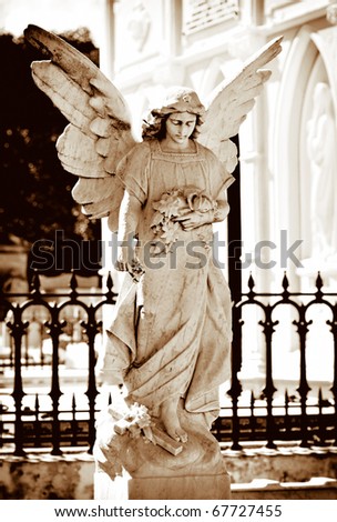stock photo Angel statue on a cemetery in golden tones