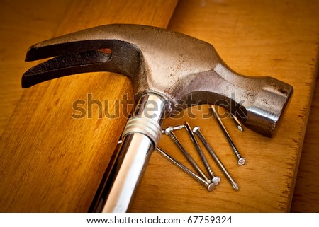 Hammer and nails on a wood background