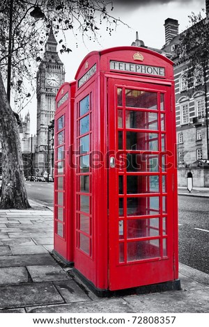 A pair of traditional red phone booths in London with the Big Ben in a desaturated background A pair of traditional red phone booths in London with the Big Ben in a desaturated background