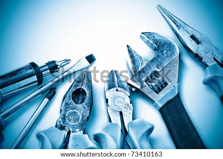 Set of manual tools on a blue background
