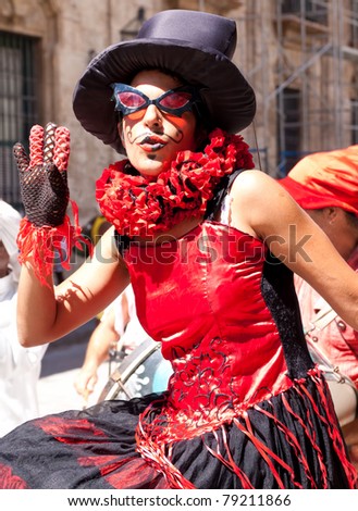 HAVANA-JUNE 4:Woman with a mask in Old Havana June 4,2011 in Havana.Artists performing in the colonial city help to give the area the colorful atmosphere which attracts over 1 million tourists a year