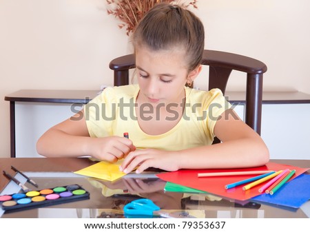 Latin girl working on her art school project at home