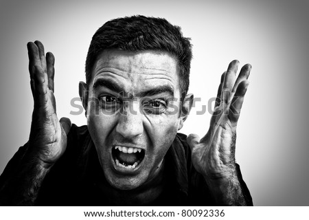 Dramatic black and white image of a man yelling with a violent or desperate face