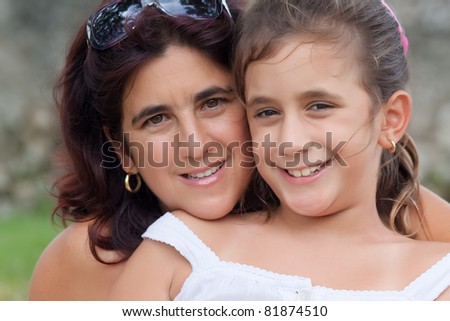 Portrait of a latin mother and daughter smiling together