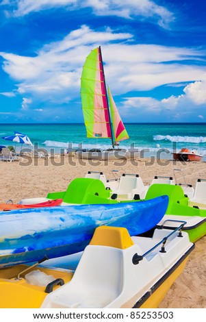 Colorful kayaks, water bikes and catamaran on the cuban beach of Varadero