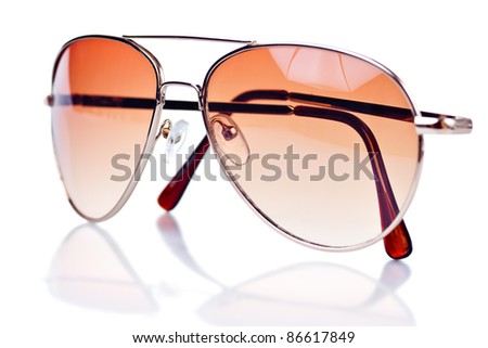 Modern brown tinted sunglasses on a white background with reflections