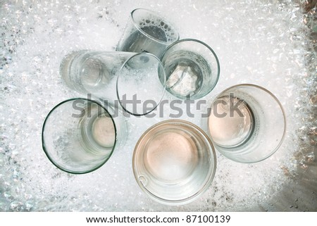 Washing dirty glasses with detergent and water