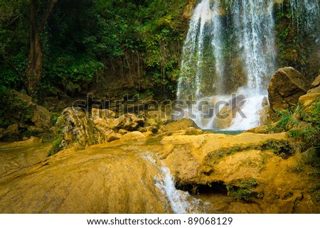 Waterfall and river flowing among rocks in the cuban natural landmark of Soroa